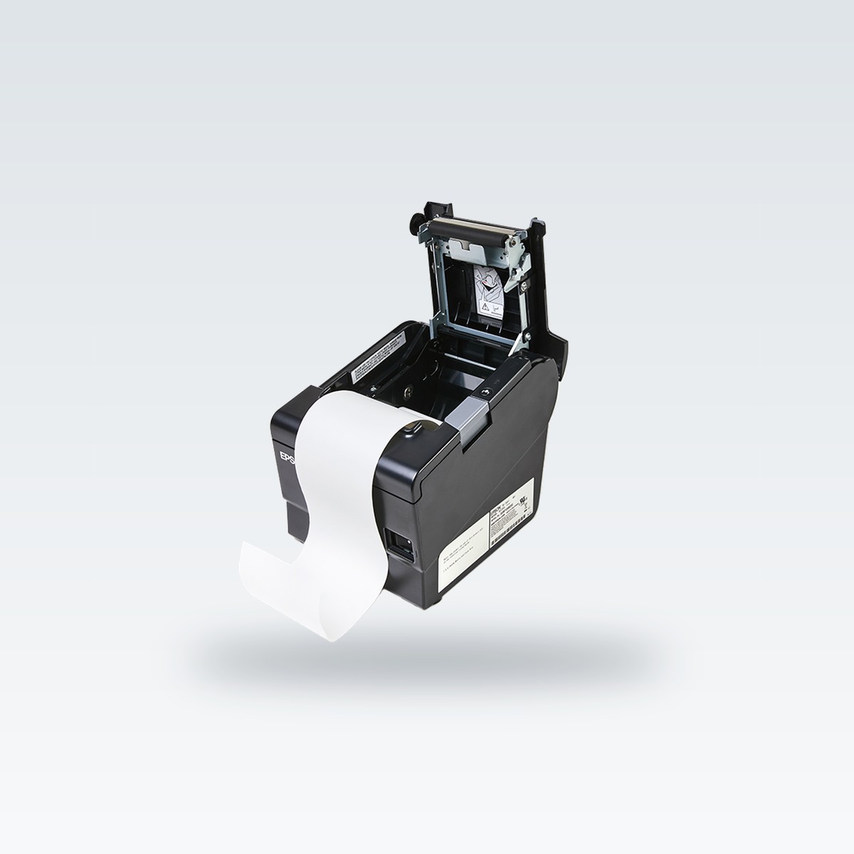 A receipt printer with its cover open and a thermal roll inside