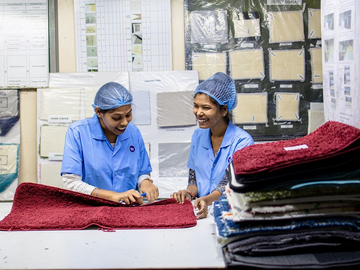 Workers inspecting fabric on a textile production line